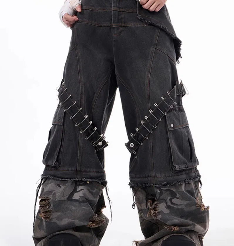 Men's grey jeans with camouflage pattern splicing and pin ribbon details on the legs.