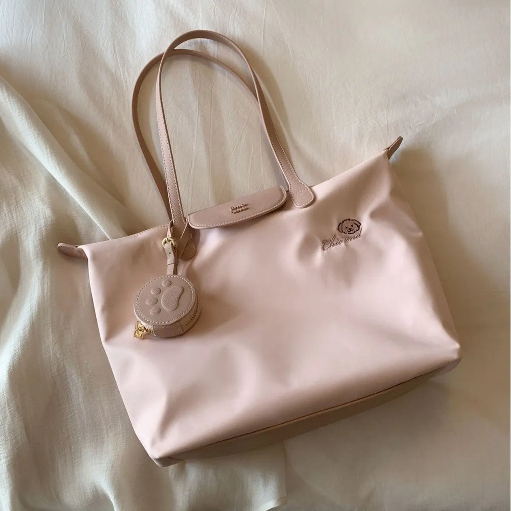 Pink Oxford cloth tote bag with sandwich pocket and shoulder strap showing sewing thread detailing