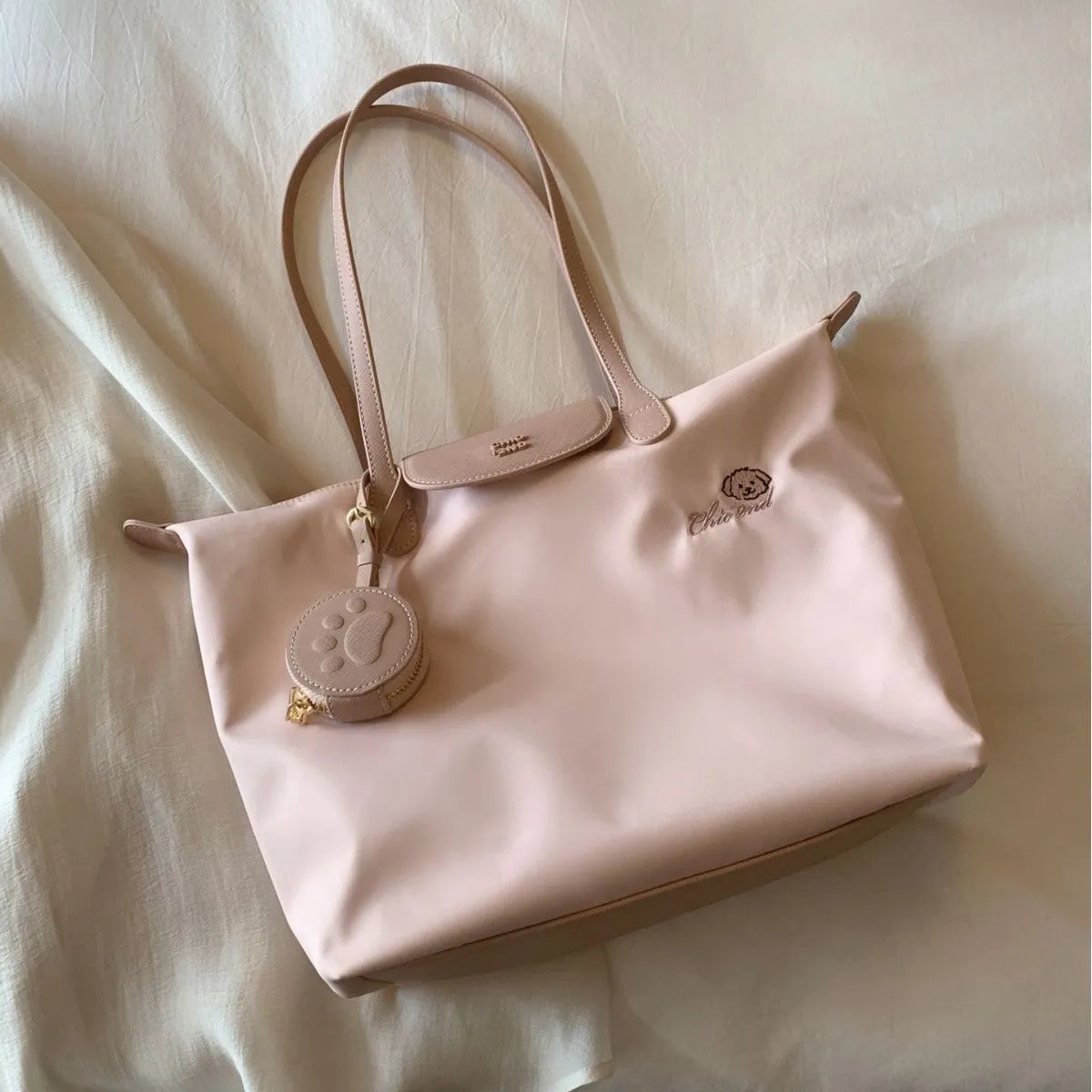 Pink Oxford cloth tote bag with sandwich pocket and shoulder strap showing sewing thread detailing