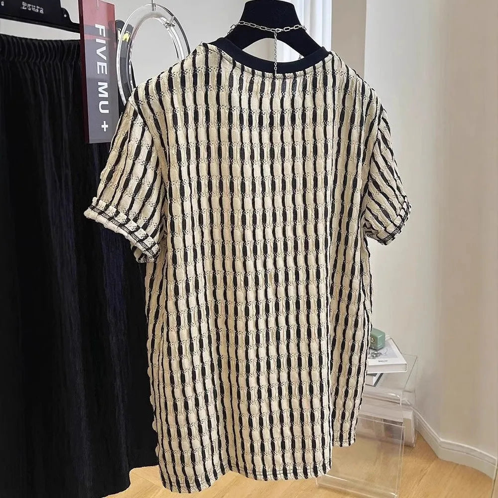 Men's black striped short-sleeve shirt with loose fit, made from linen and silk blend, shown in casual wear.