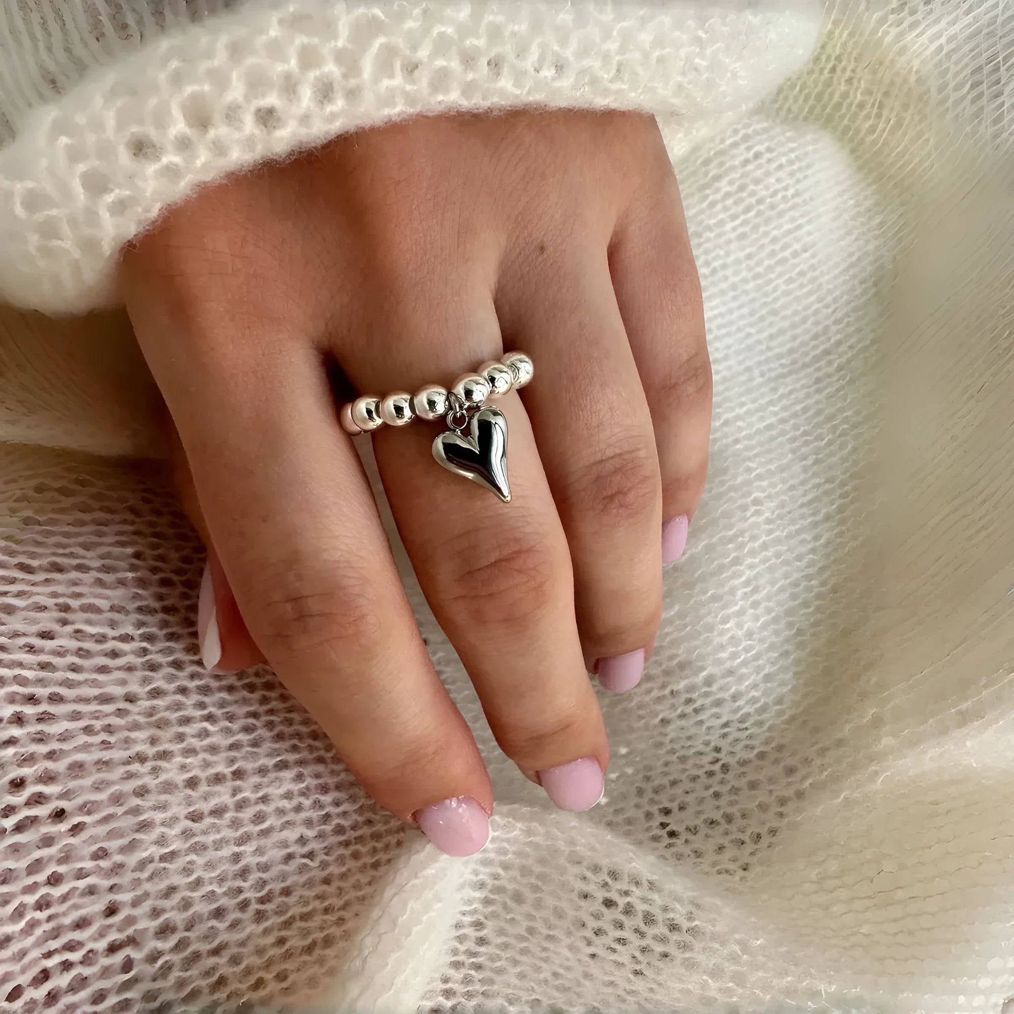 Handmade beaded elastic love ring with geometric heart design in gold and white colour options