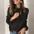 Women's loose fit hollow lace shirt in street style, showing round neck and long sleeves.