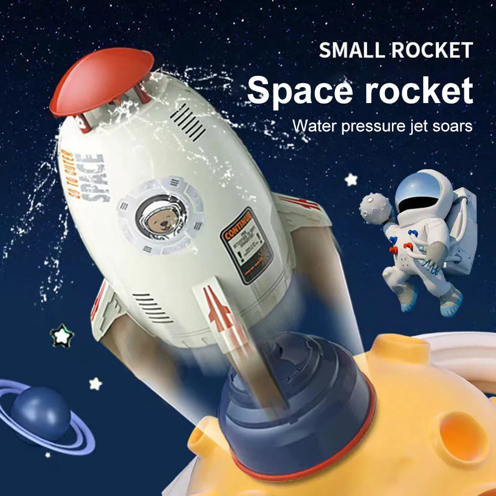 Yellow water pressure rocket launcher toy for kids outdoor garden play on a green lawn.