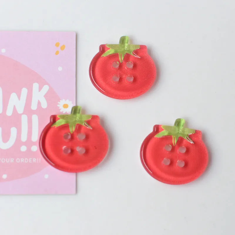 Medium size red tomato pattern button ornaments made from plastic resin, shown in different colour variations.