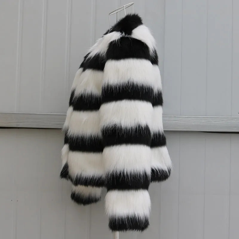 Black and white striped faux fur jacket with long sleeves on female model