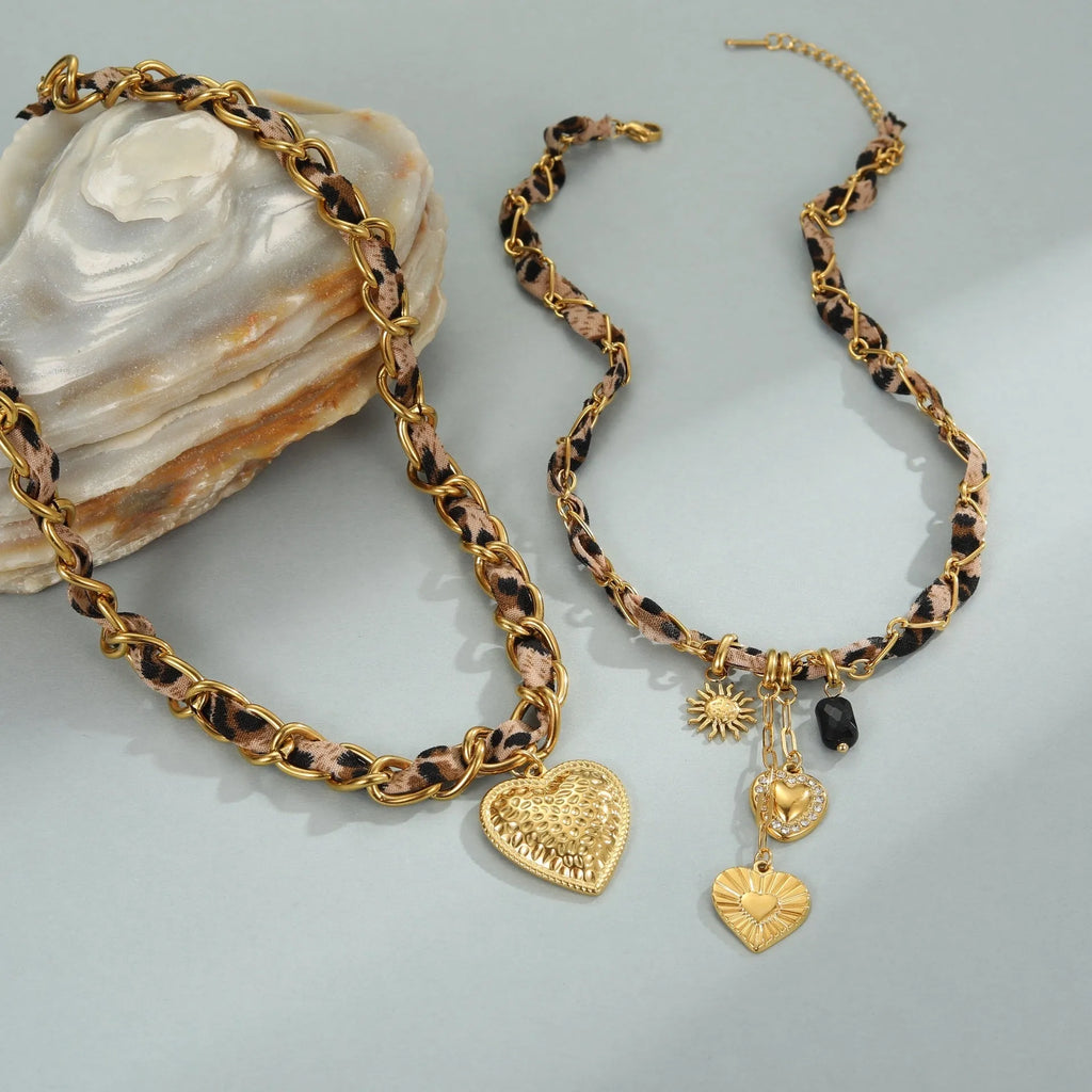 Close-up of a stainless steel necklace with a geometric leopard love pendant on an adjustable 18K-plated chain.