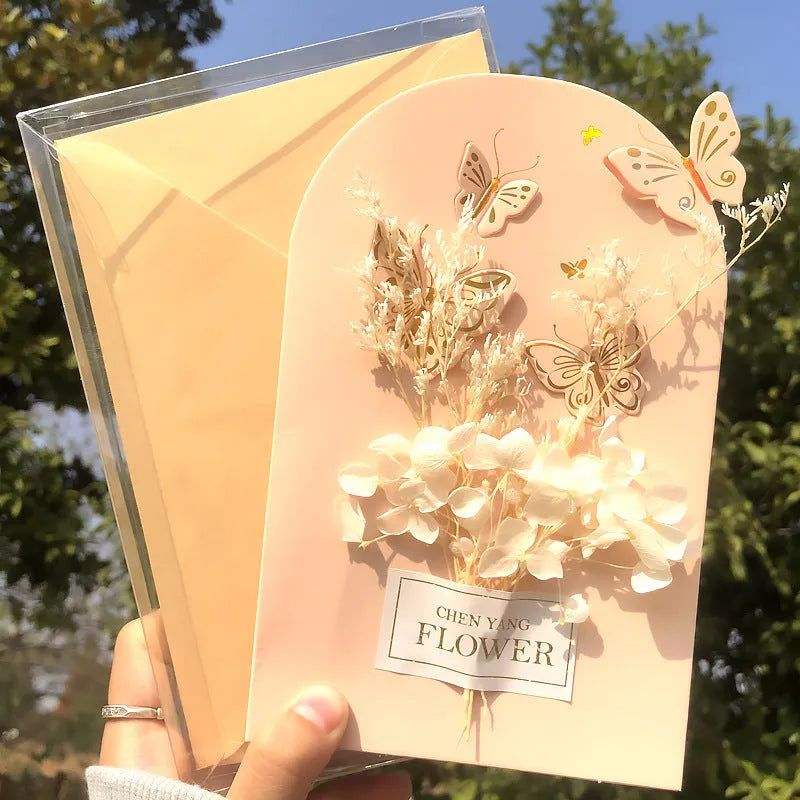 Handmade 3D butterfly greeting card showing stand-up design with artificial flowers on coated paper