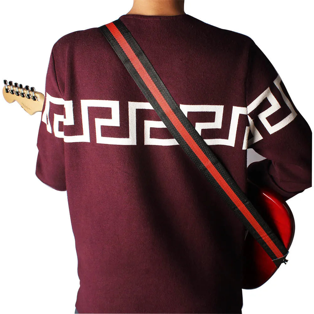 Woven crossbody strap for musical instruments in five colour options on guitar