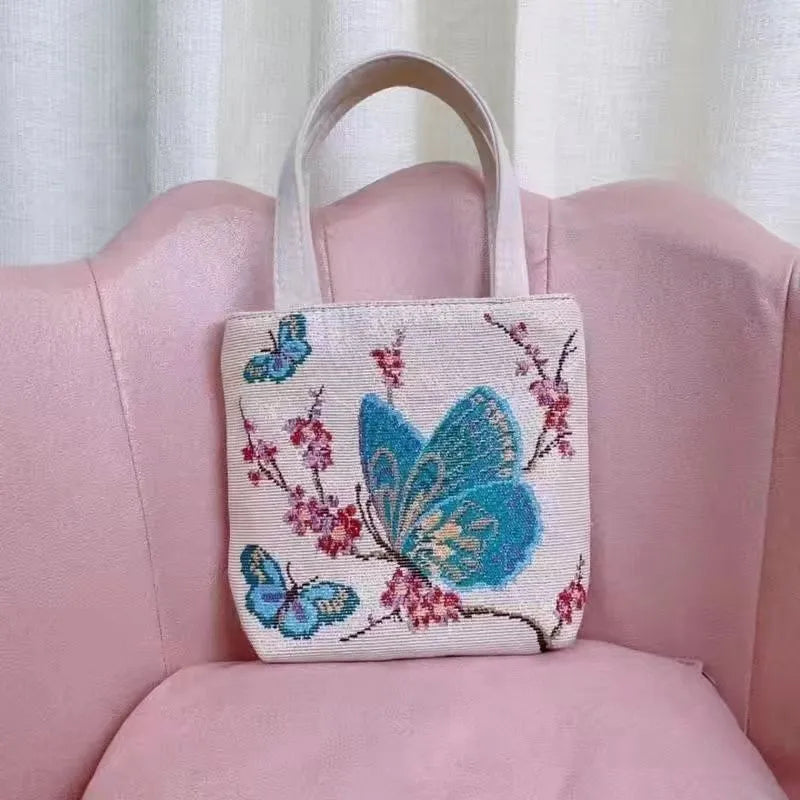 Gold wire embroidered canvas handbag showing bunny design, with polyester lining and top handles.
