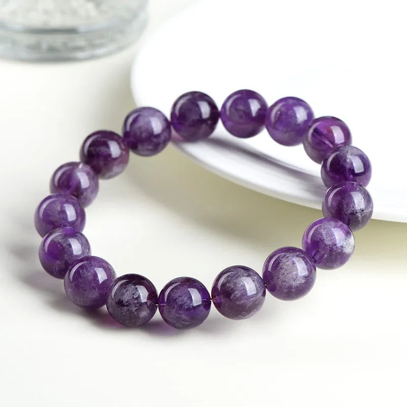 Natural feather amethyst crystal bracelet with scattered geometric beads showing purple crystal patterns and Ruyi elements