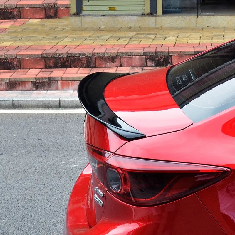 Bright black Mazda 3 Axela Exela tail trim with large fixed wind surround for 2014-2021 models