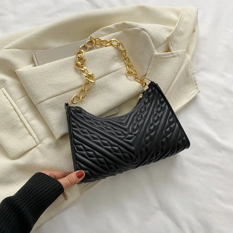 Brown pleated chain baguette shoulder bag with adjustable strap and soft carry handle showing three-dimensional pocket design