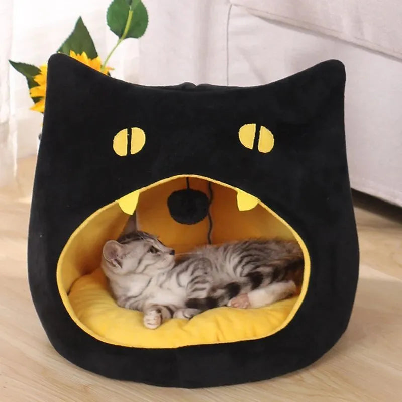 Grey covered cat cave pet bed with cat face design and anti-slip bottom.
