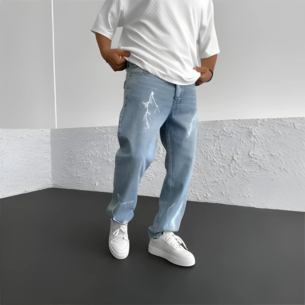 Men's blue straight-leg jeans with a loose wide-leg cut and printed design.