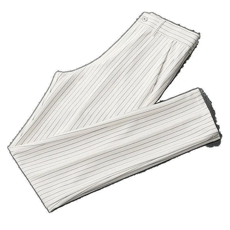 Man wearing loose fit thin striped suit pants in a crop jeans style, available in black or white.