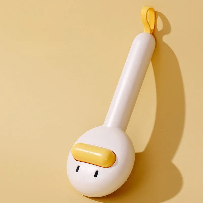 Small yellow duck-shaped comb for pet grooming with open section and needle bristles