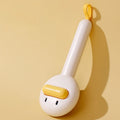 Small yellow duck-shaped comb for pet grooming with open section and needle bristles