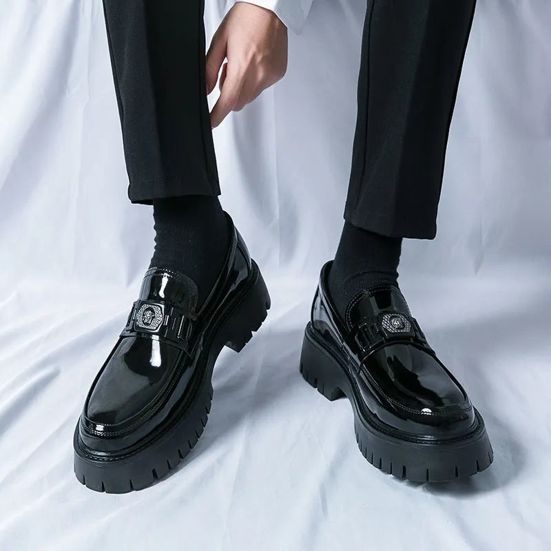 Men's black glossy PU leather loafers with a low platform sole, shown in a summer setting.