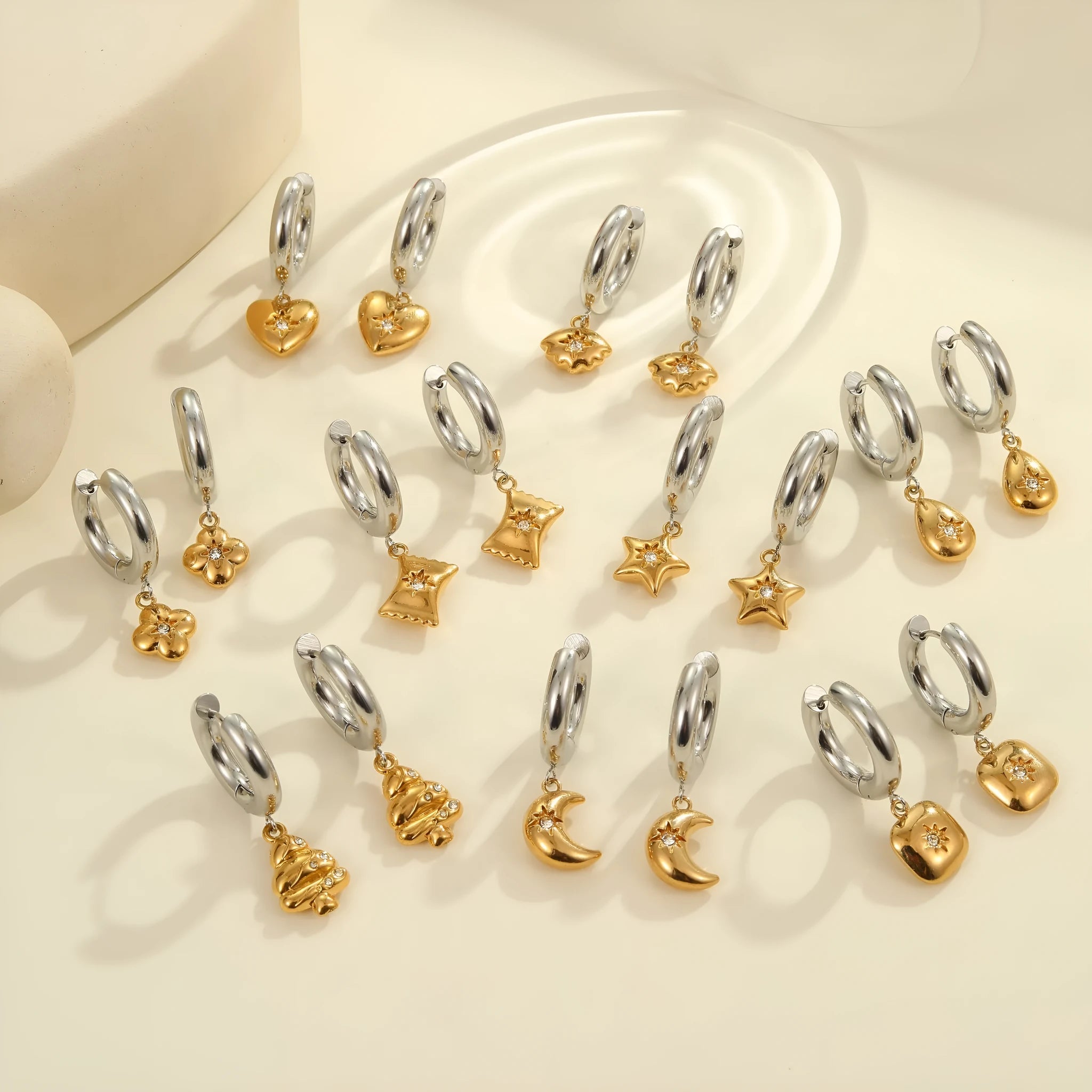 A pair of stainless steel Christmas tree and heart shaped earrings with 18K gold electroplating.
