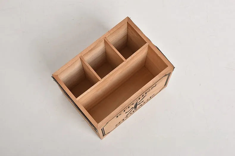 Wooden kitchen storage box with internal grid divider for organising knives, forks, and chopsticks.