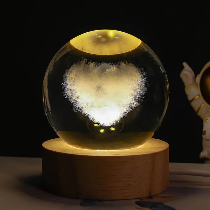 3D crystal ball night light projecting starry sky and planets from its 6cm sphere on a solid wood base.