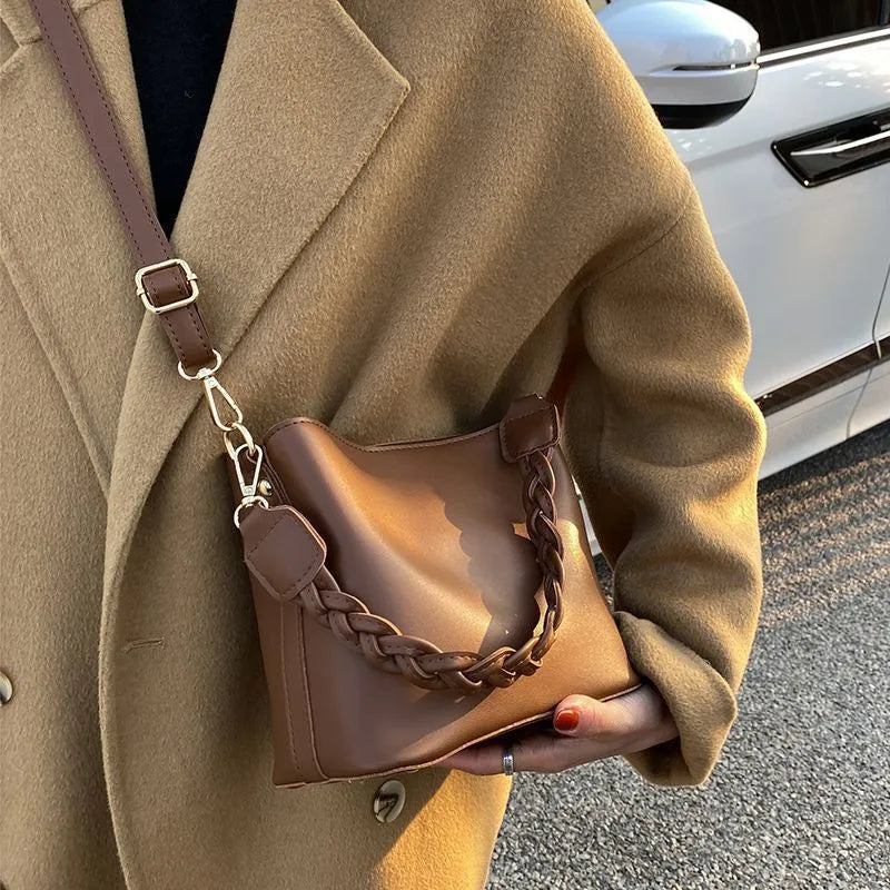 Fashion retro one-shoulder crossbody underarm bucket bag in woven PU with adjustable strap, shown in khaki colour.
