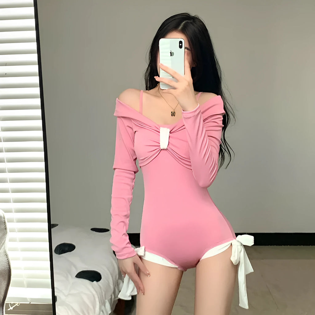 Women's long sleeve one-piece swimsuit in black or pink polyester.
