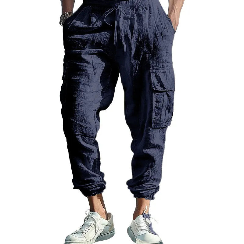 Men's loose-fit linen trousers with ankle ties and multiple pockets in solid colours