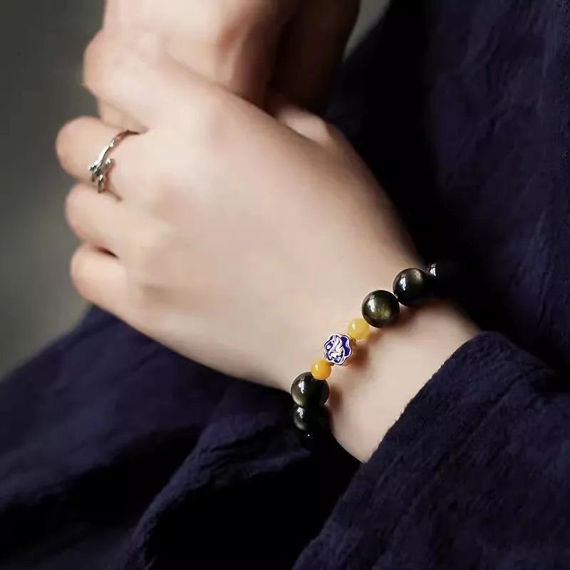 Golden obsidian bracelet with hand-carved Chinese zodiac animal beads in geometric shapes