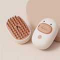 White or yellow Cat Steam Brush with silicone teeth and rechargeable spray for grooming dogs and cats