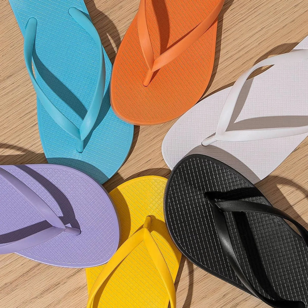 Foldable beach slippers with non-slip PVC soles and hollow-out plastic uppers in orange, purple, black, or white