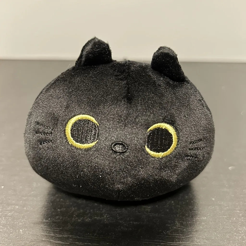 Fluffy black cat plush toy with soft texture, shown as a decorative cushion