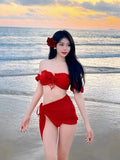Red women's bikini swimsuit with puff sleeve skirt briefs on hanger