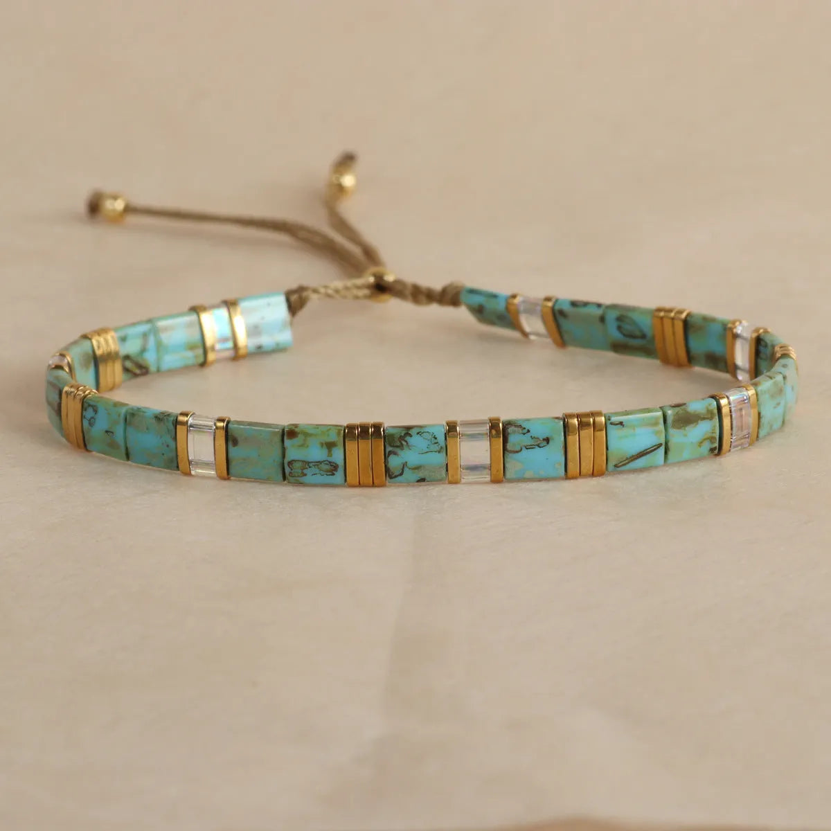 Geometric glass beads bracelet in five colour options showing 8mm beads and secure clasp on wrist