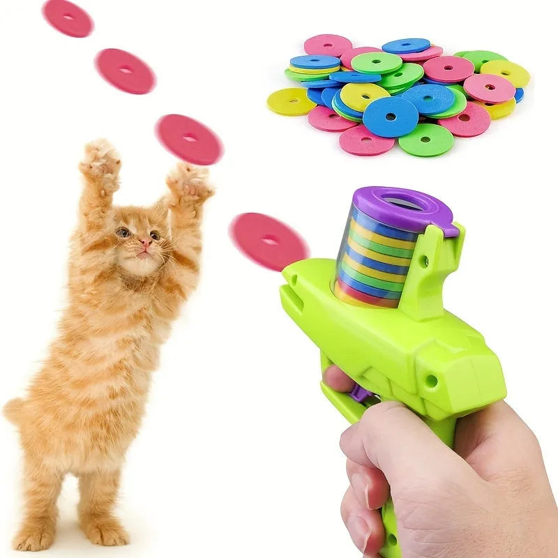 Green interactive cat toy launcher with foam discs on wooden floor