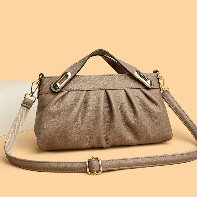 Leather niche pleated shoulder crossbody bag in black with horizontal square shape, multiple interior pockets and soft composite leather.