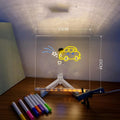 Acrylic DIY LED message board night light on a desk with handwritten drawing glowing softly.