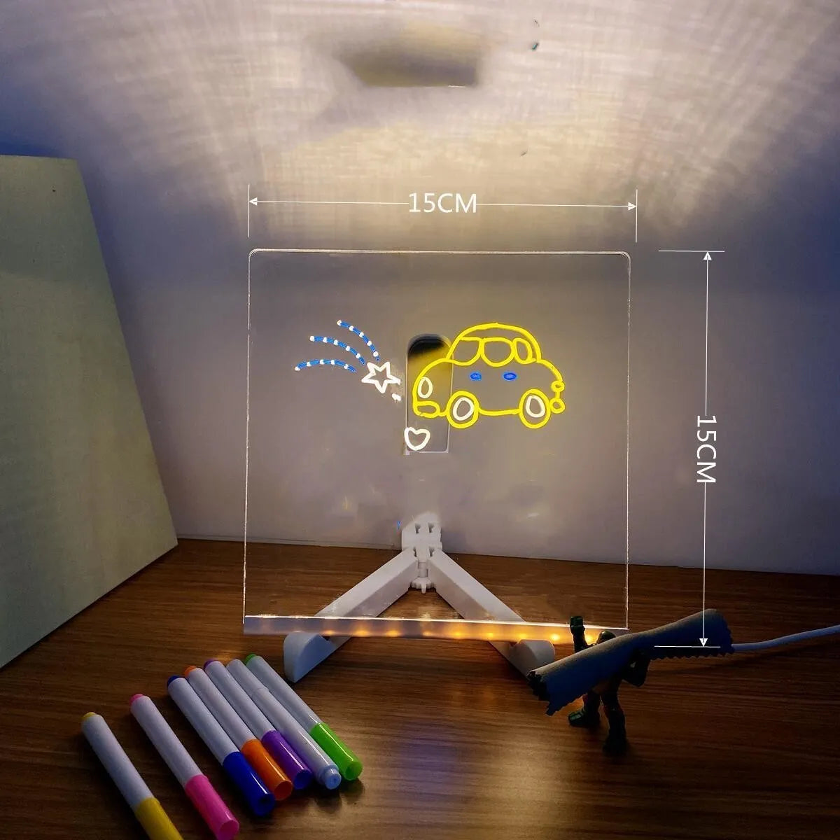 Acrylic DIY LED message board night light on a desk with handwritten drawing glowing softly.