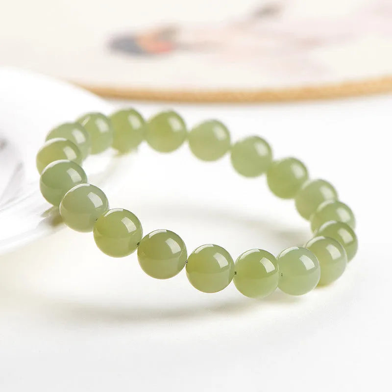 Hetian jade ball bracelet with polished beads in ice-like clear water colours, showing 4mm to 10mm size options
