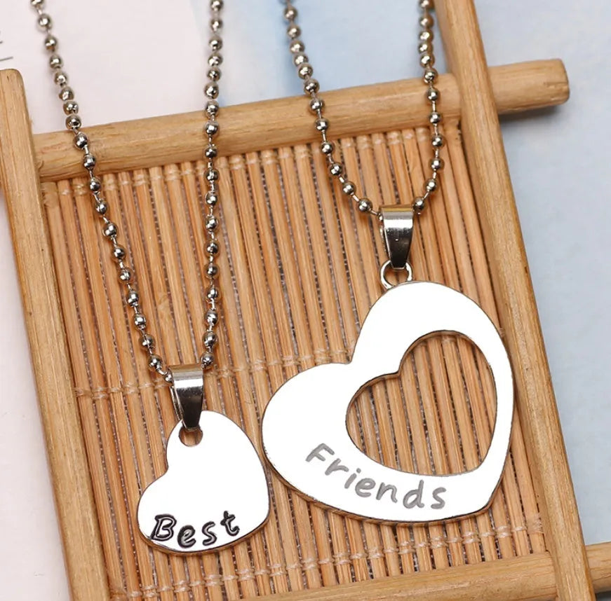Two-piece silver alloy necklace set with heart-shaped pendants and cross chains in a love design