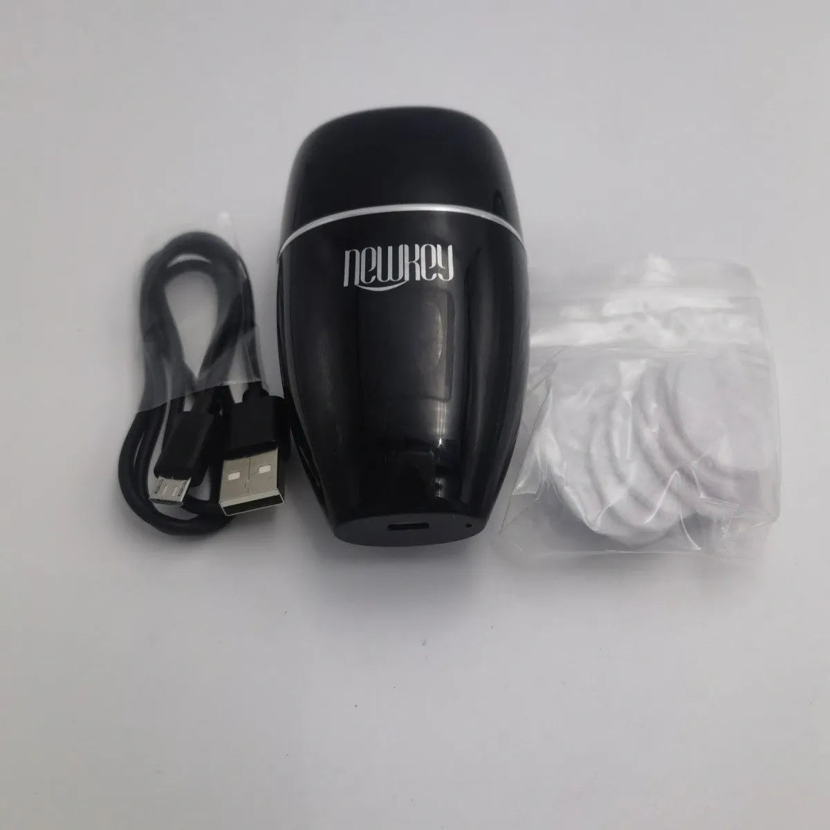 Black electric lip plumper with silicone nozzle and USB cable