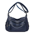 Large blue PU leather women's crossbody bag with zipper closure showing internal organiser pockets