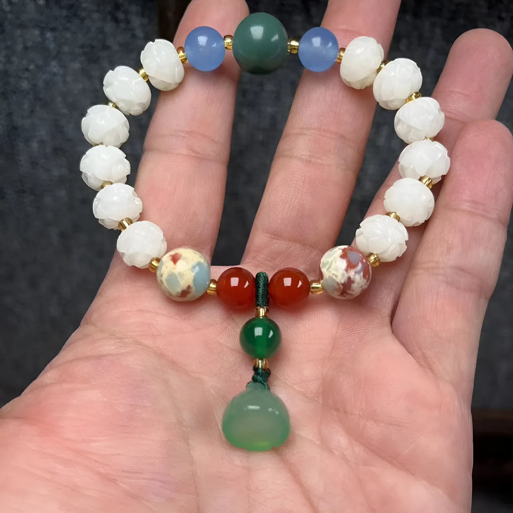 Hand-carved Bodhi root bracelet with White Jade beads, lotus carvings, and a cat's paw pendant.