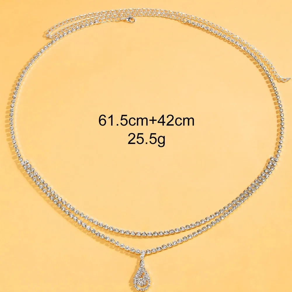 Gold adjustable waist chain with rhinestone water drop pendant and lobster clasp on mannequin
