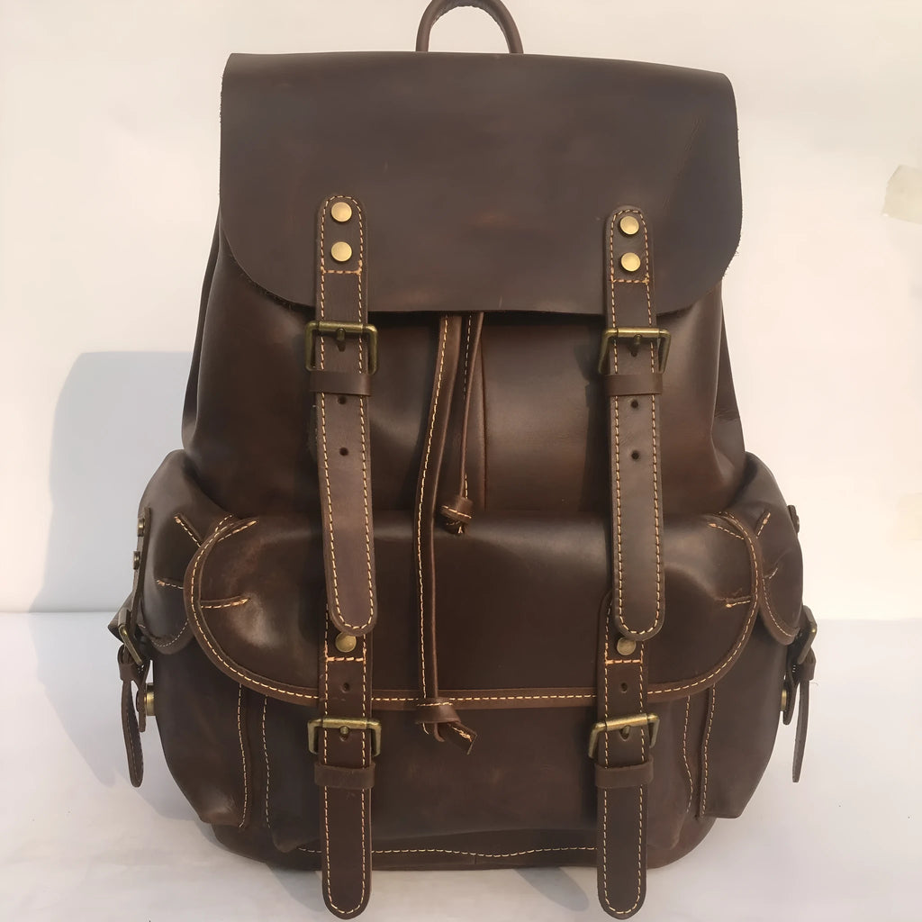 Brown men's genuine cowhide leather backpack with air pillow belt straps.