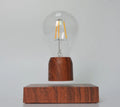 Magnetic levitation bulb floating above imitation wood base with ABS and glass construction, EU CE certified for 100-240V operation