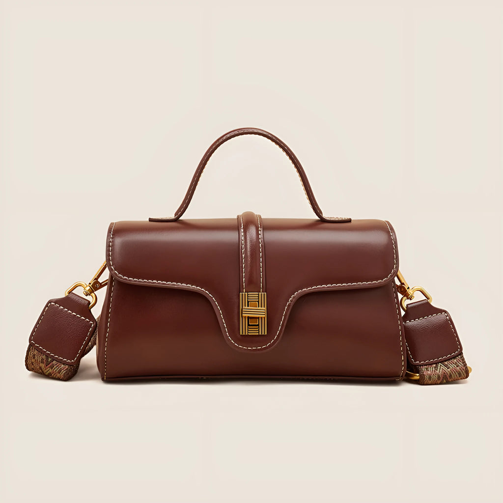 Brown Cambridge-style leather messenger bag with a front lock, shown open to reveal internal zipper pockets.