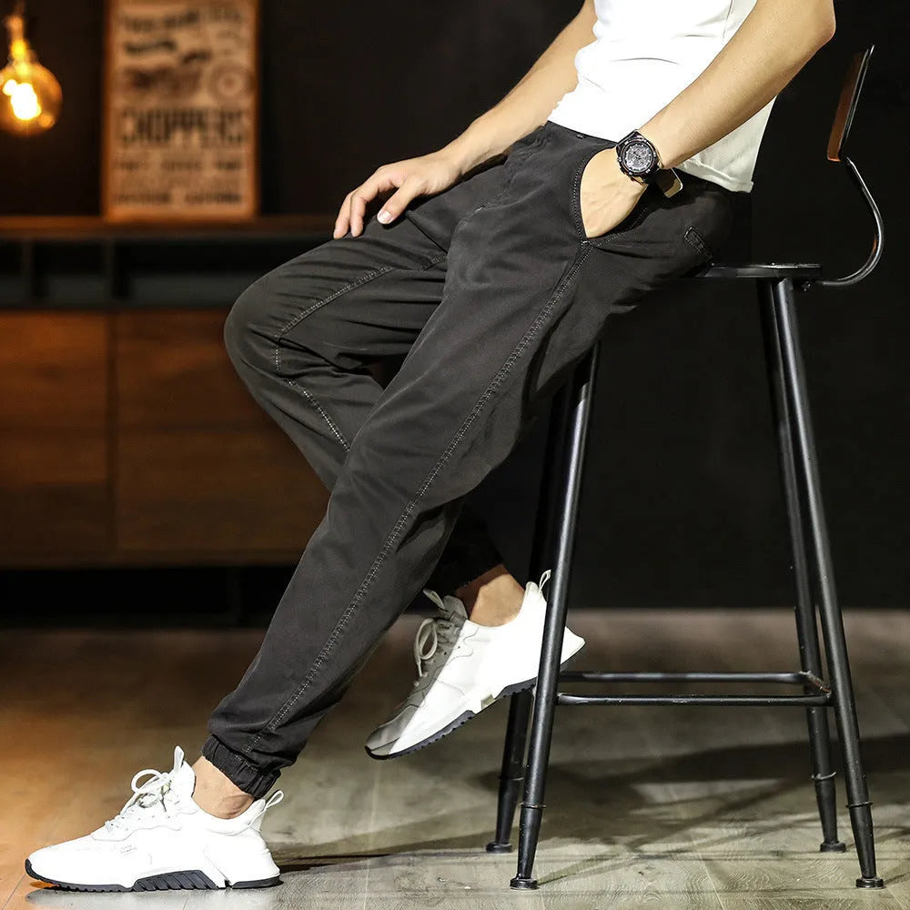 Men's cotton tapered casual trousers with ankle-tied hem, mid waist and zipper fly in khaki, black, coffee army or medium grey.