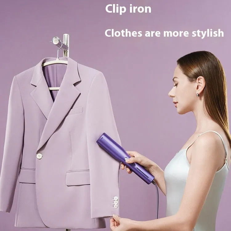 Handheld garment steamer showing its nozzle, controls, and plastic clip on a white background.