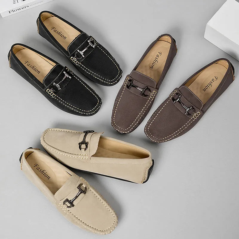 Men's beige slip-on loafers with a round toe and rubber sole on a plain background.